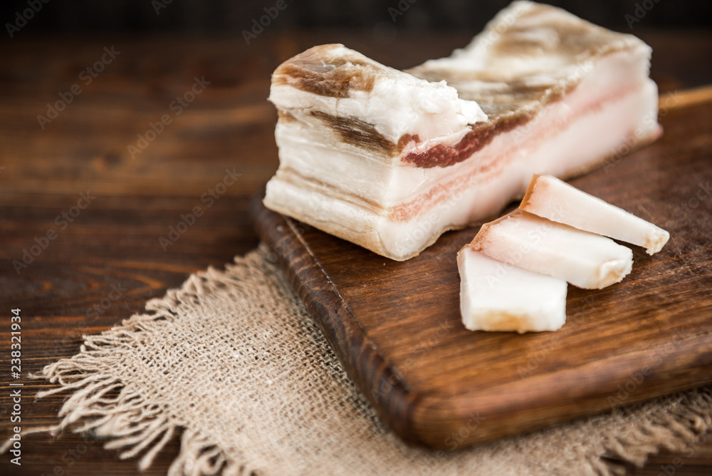 Salt pork fat on dark wooden