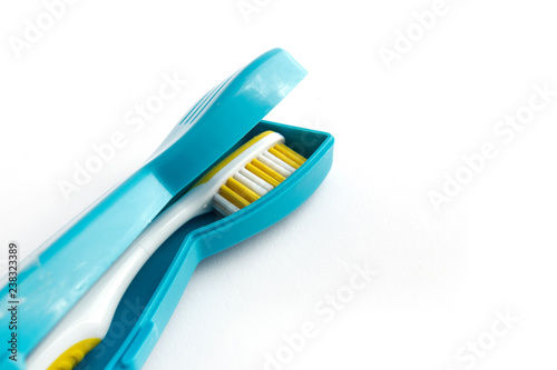 Toothbrush with a plastic case isolated on white background