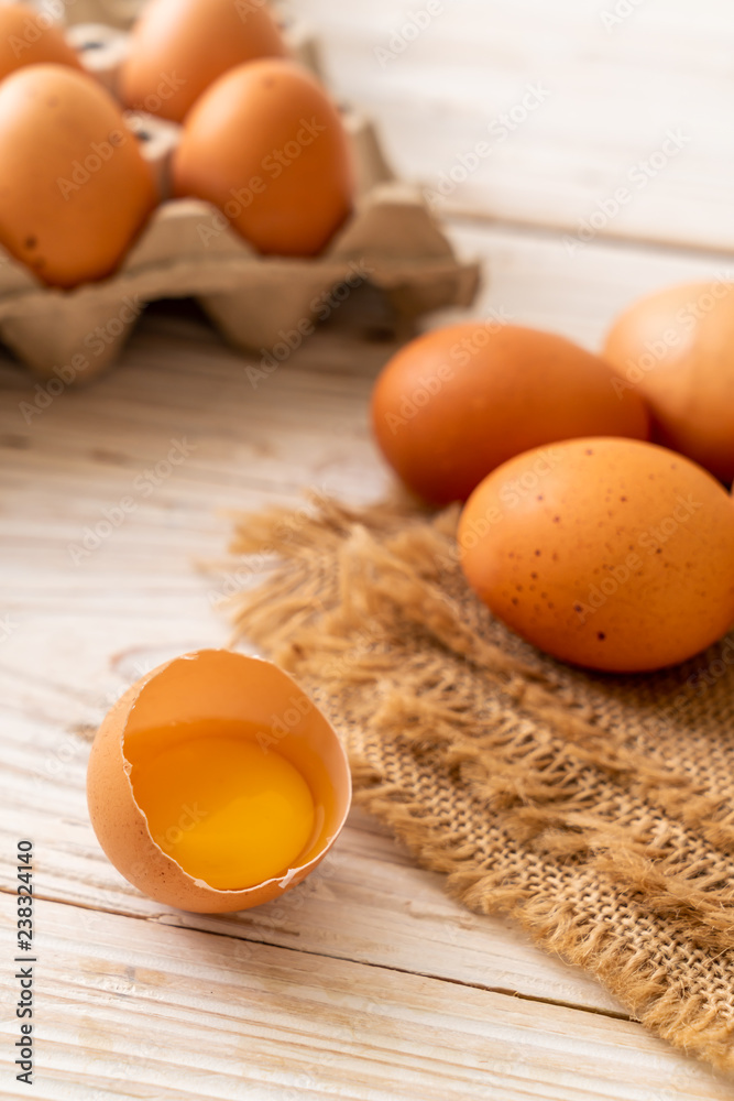 Brown eggs with one broken and egg yolk Brown eggs with one broken and egg yolk