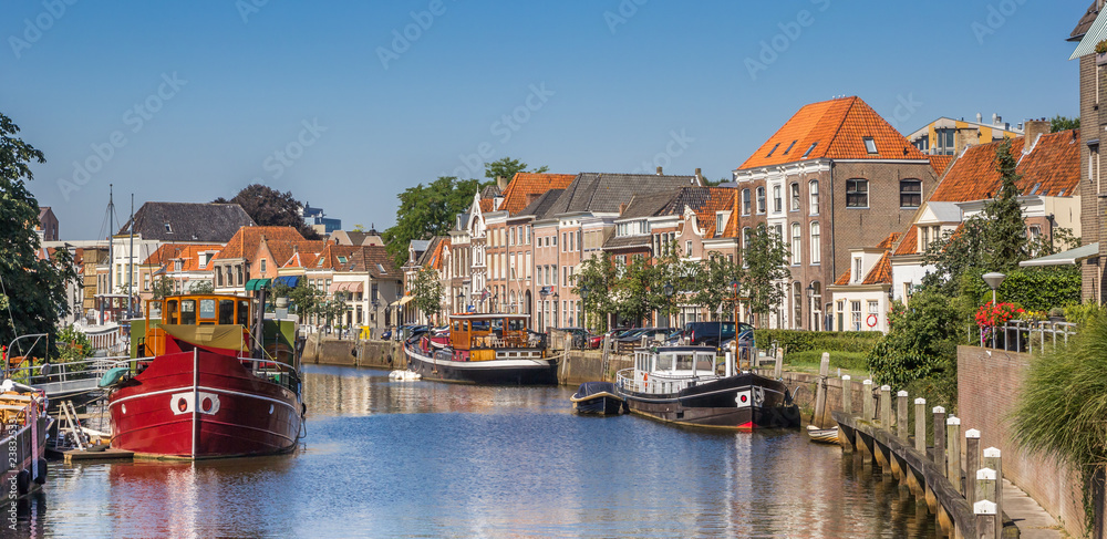Panorama of a canal with old ships and historical houses in Zwolle