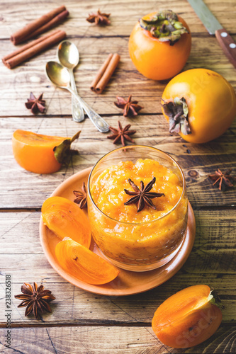 Persimmon fruit smoothie with cinnamon and anise stars, wooden table