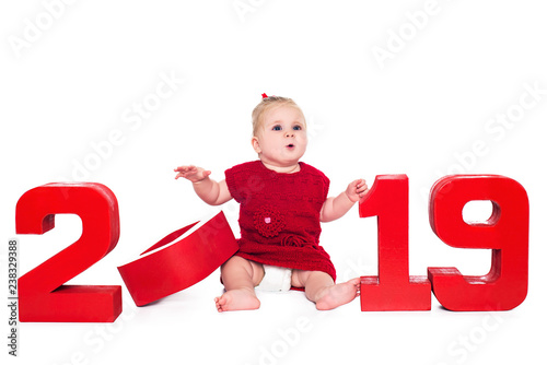 Surprised cute baby girl with red numbers 2019, isolated over white background