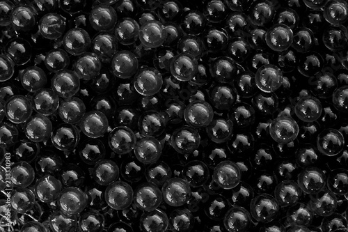 Water black gel balls with bokeh. Polymer gel. Silica gel. Balls of black hydrogel. Crystal liquid ball with reflection. Black texture background. Macro © Fernando.RM