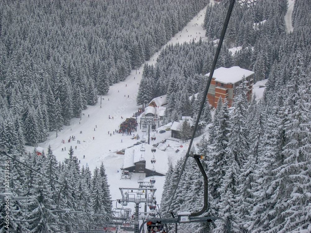 Ski resort, people on the lift among the white pines. Alpine village. Low Tatras, Slovakia. Ski resort, people on the lift among the white pines. Alpine village. Low Tatras, Slovakia.