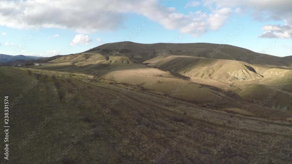 Quadrocopter flies over the valley with hills and spots of light on them Quadrocopter flies over the valley with hills and spots of light on them