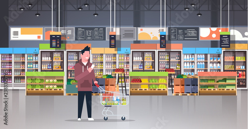 supermarket man customer checking shopping list carrying trolley cart male shopper buying products grocery market interior flat horizontal
