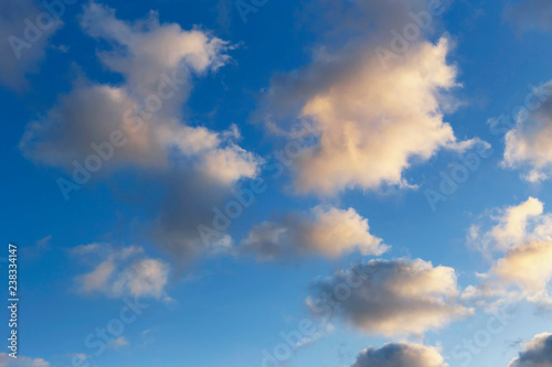 beautiful blue sky with sunlit clouds as a natural background