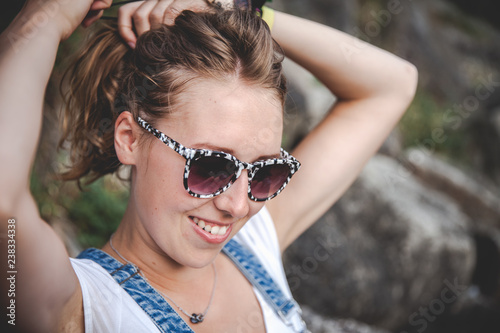 beautiful young blond woman with sunglasses in the nature summer