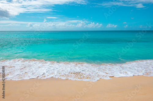 Turquoise blue sea and tropical beach of Mullet Bay, Sint Maarten, Caribbean.