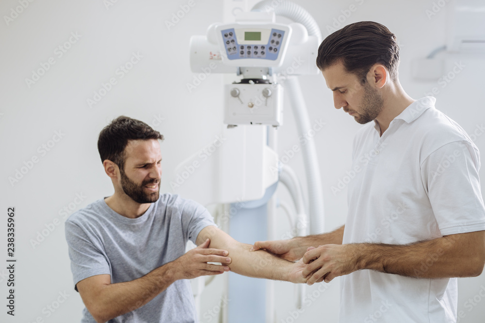 Fototapeta premium Doctor Examining Patient's Hand