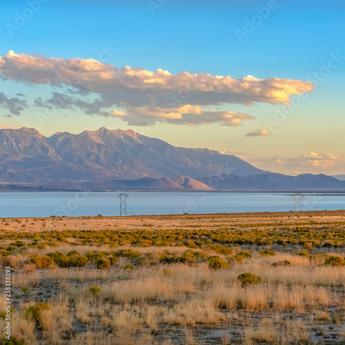 Utah Lake and mountain beyond a grassy terrain
