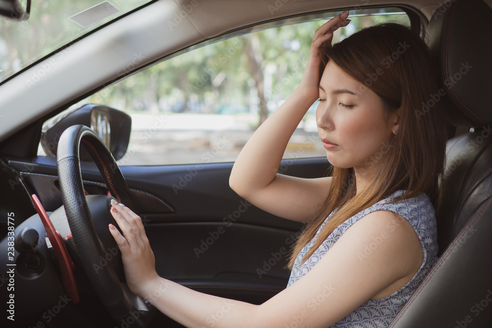 Stressed of asian woman driver sitting inside her car.