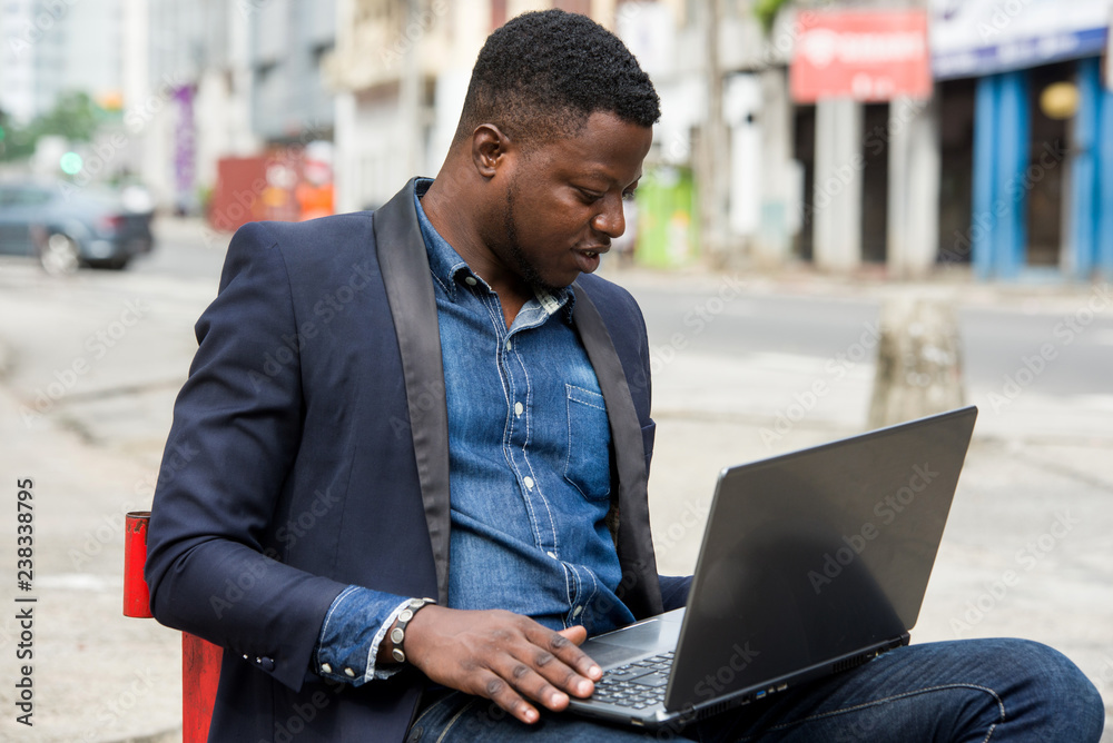 portrait of young man with laptop.
