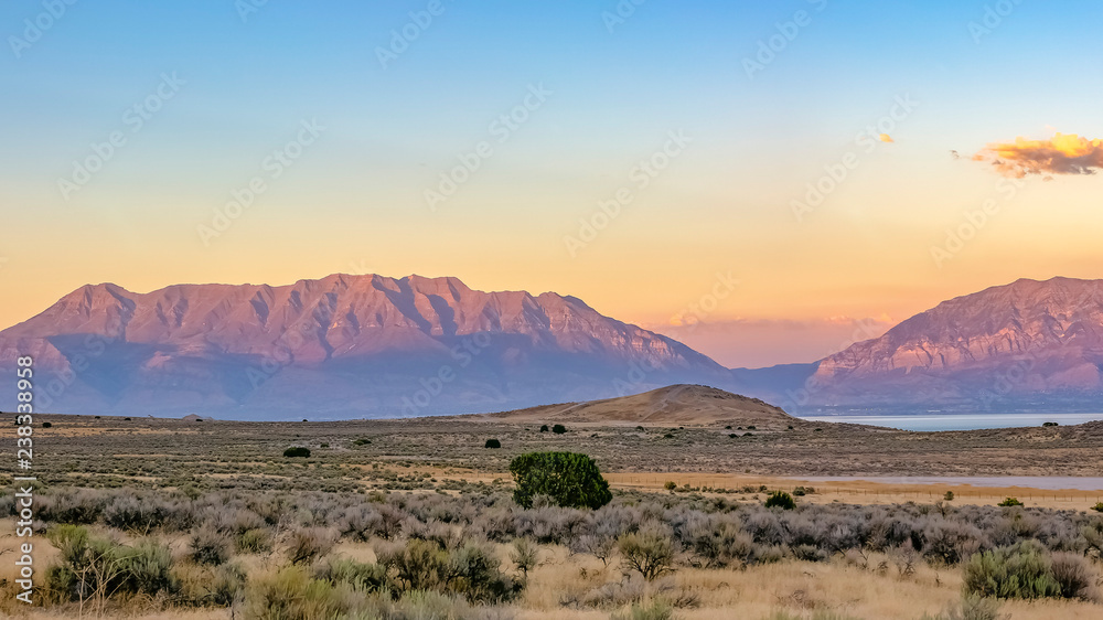 Utah Lake bordered by rugged terrain and mountains