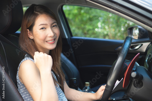 Young asian woman driving a car. © structuresxx
