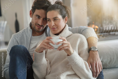  Attractive modern couple relaxing at home looking at camera © goodluz
