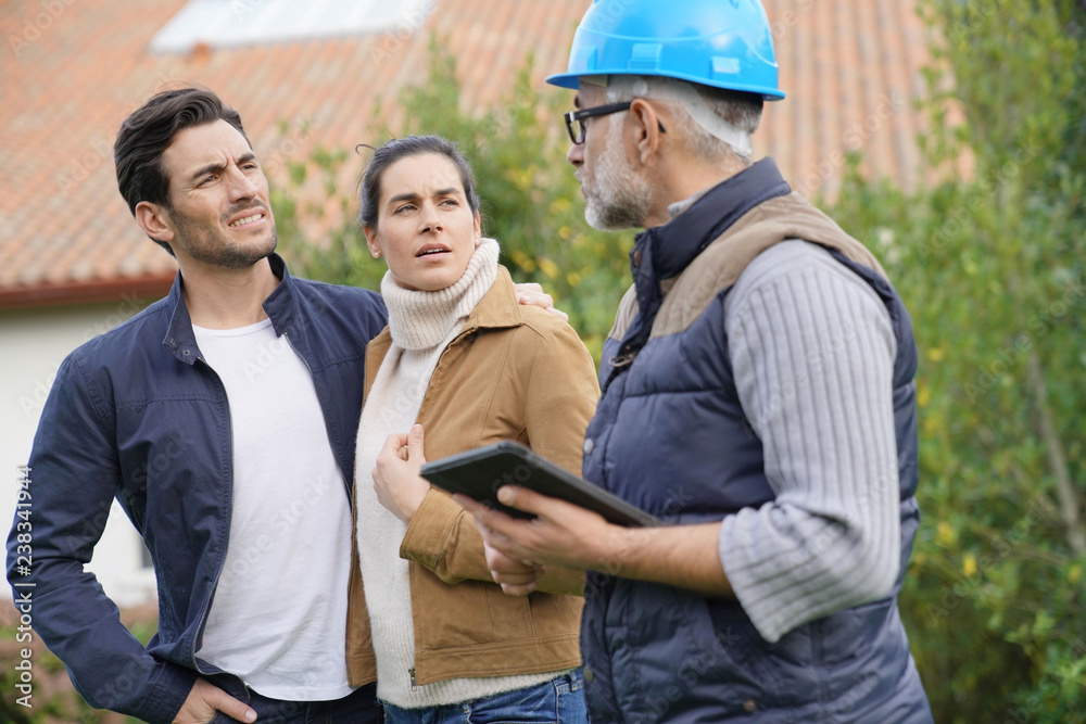 Builder going through outdoor plans with homeowners Builder going through outdoor plans with homeowners