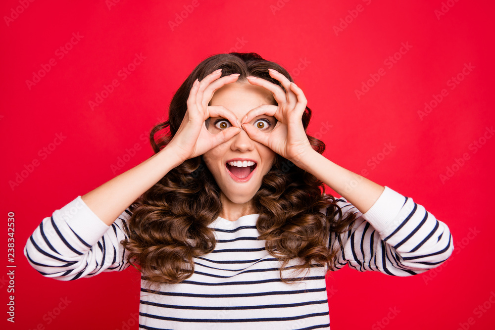 Close up portrait of attractive gorgeous charming she her girl brunette hands in specs form near eyes long wave hair lying on shoulders white striped pullover isolated on red bright vivid background Close up portrait of attractive gorgeous charming she her girl brunette hands in specs form near eyes long wave hair lying on shoulders white striped pullover isolated on red bright vivid background