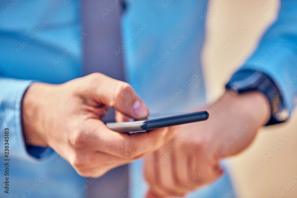Businessman using his smartphone on the street. Businessman using his smartphone on the street.