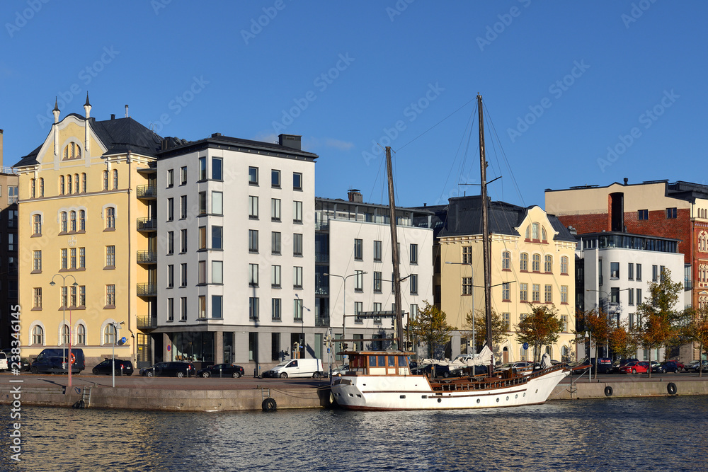 Pohjoisranta embankment and harbor with old yacht in raid. Katajanokka. Helsinki, Finland