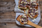 sinabon with cream cheese and cream, chocolate and cashew nuts on wooden background