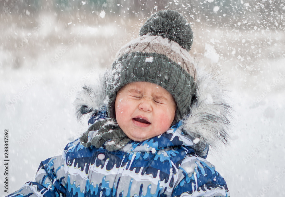 Little boy on snowy day playing snowballs Little boy on snowy day playing snowballs