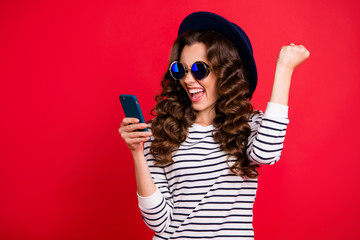 Portrait of cool well-groomed attractive gorgeous positive wavy-haired lady wearing in eyeglasses eyewear pullover reading getting notification isolated over bright vivid shine red background