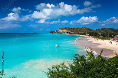 Tropical beach at Antigua island in Caribbean with white sand  turquoise ocean water and blue sky
