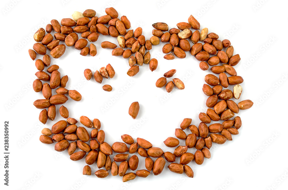 Dried and beautifully lying peanuts on a white background. Dried and beautifully lying peanuts on a white background.