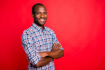 Profile side view portrait of nice handsome well-groomed trendy attractive cheerful positive cheery guy wearing checked shirt beaming smile isolated over bright vivid shine red background