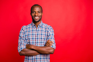 Portrait of nice handsome well-groomed attractive cheerful positive cheery guy wearing checked shirt isolated over bright vivid shine red background