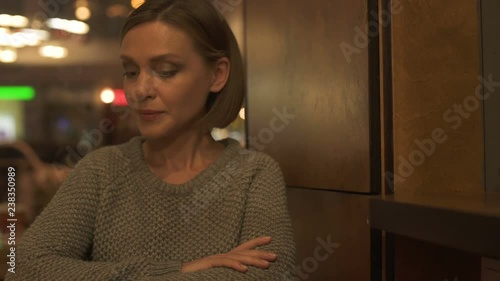 Nervous woman sitting in cafeteria waiting for boyfriend, blind date service