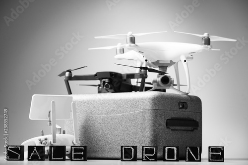 Flying drones on a white background with inscriptions "sale drone"
