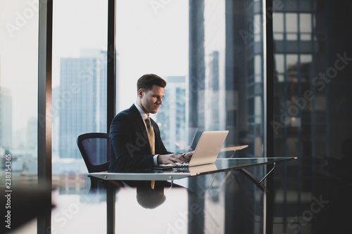 Businessman working in executive office in a skyscraper photo