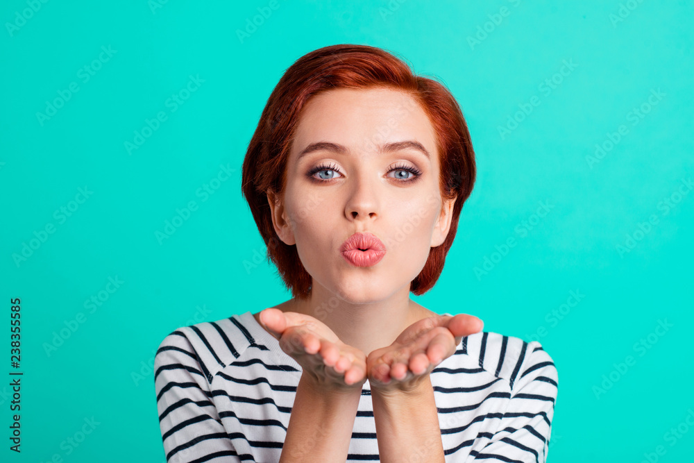 Obraz premium Close-up portrait of nice attractive lovely lovable red-haired lady in striped pullover sending air kiss isolated over bright vivid shine green turquoise background