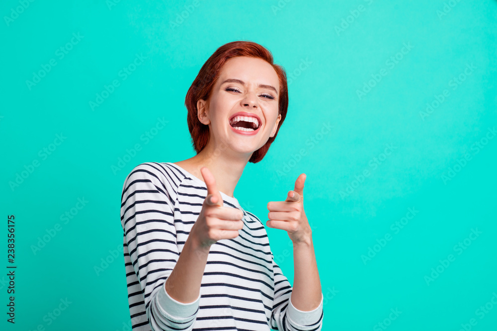 Portrait of nice pretty attractive cheerful cheery red-haired lady wearing striped pullover pointing forefingers mockery isolated over bright vivid shine green turquoise background Portrait of nice pretty attractive cheerful cheery red-haired lady wearing striped pullover pointing forefingers mockery isolated over bright vivid shine green turquoise background