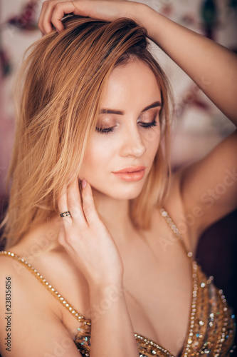 Close-up portrait of sexy blonde woman looking down