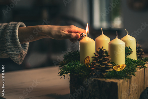 lighting a candle on advent wreath