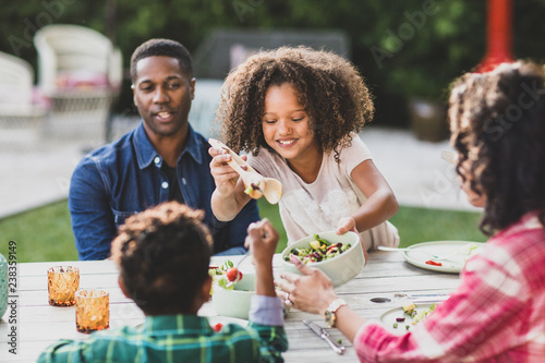 African American family having a family meal outdoors photo