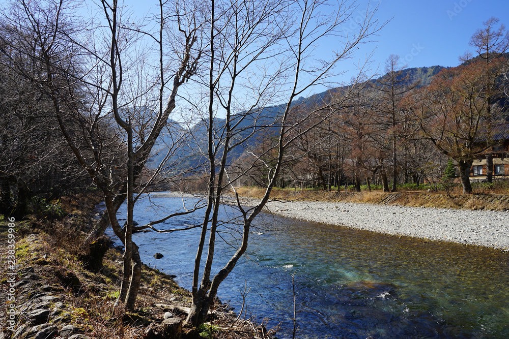 Beautiful crystal clear water river landscape with mountain background in Japan Alps Kamikochi