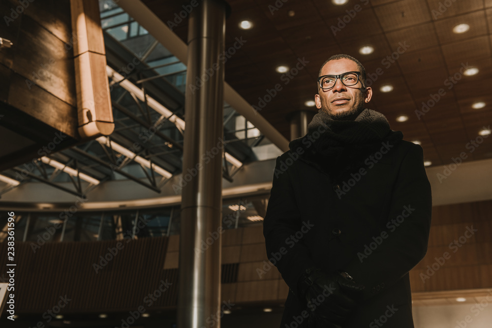Adult black man inside modern building Adult black man inside modern building
