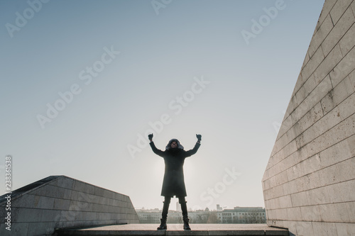 Black male celebrating success on street steps photo
