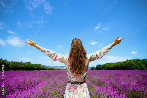 young woman at lavender field in Provence, France rejoicing