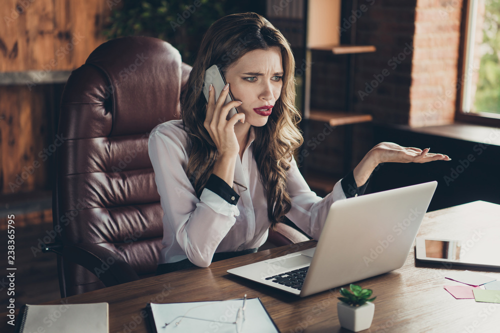 Portrait of nice lovely attractive charming clever smart intelligent wavy-haired lady company director founder phone negotiation in front of laptop at workplace station