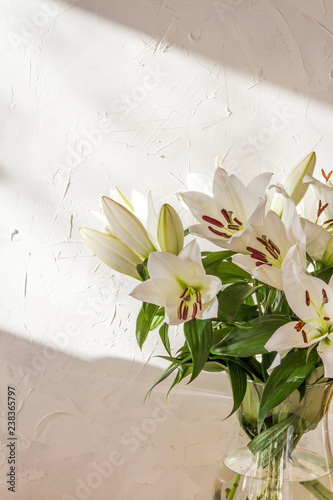 Fototapeta Naklejka Na Ścianę i Meble -  Flower bouquet, white lilies in a vase. White background. 