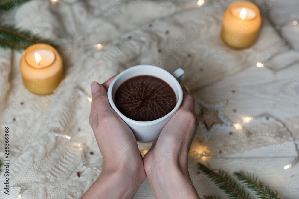 Female hand holding cup of hot Cocoa or Chocolate