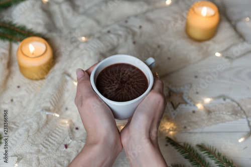 Female hand holding cup of hot Cocoa or Chocolate