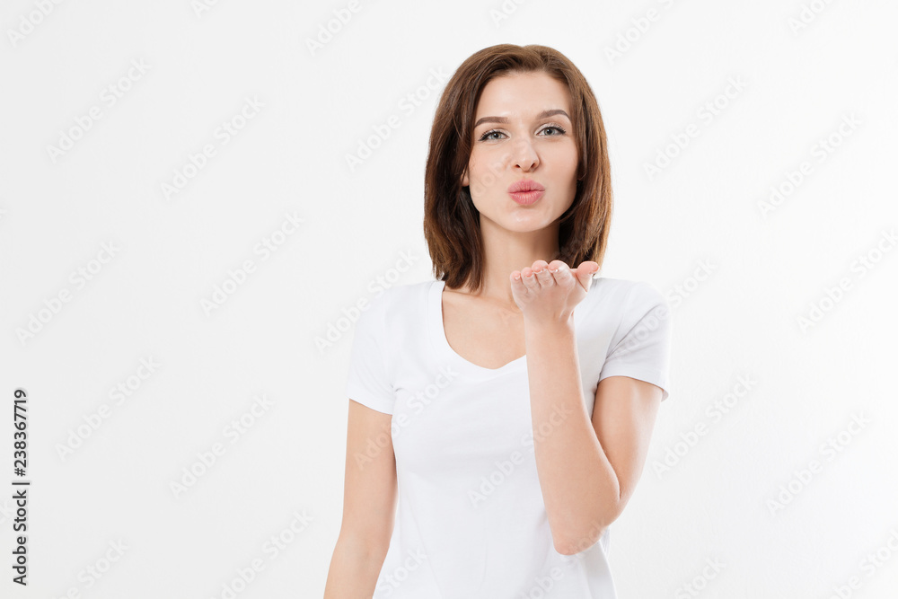 Young girl showing kiss love sign isolated on white background. Copy space. Valentine day. Mock up. Summer woman clothes blank template white t shirt.