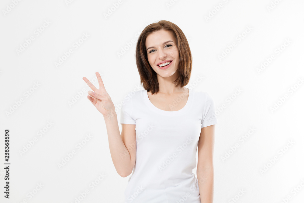 Happy young caucasian girl showing victory sign isolated on white background. Copy space. Template and blank summer t shirt. - obrazy, fototapety, plakaty 