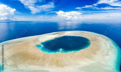 Fototapeta Naklejka Na Ścianę i Meble -  Aerial idyllic atoll, scenic travel destination Maldives Polinesia. Blue lagoon and turquoise coral reef. Shot in Wakatobi National Park, Indonesia